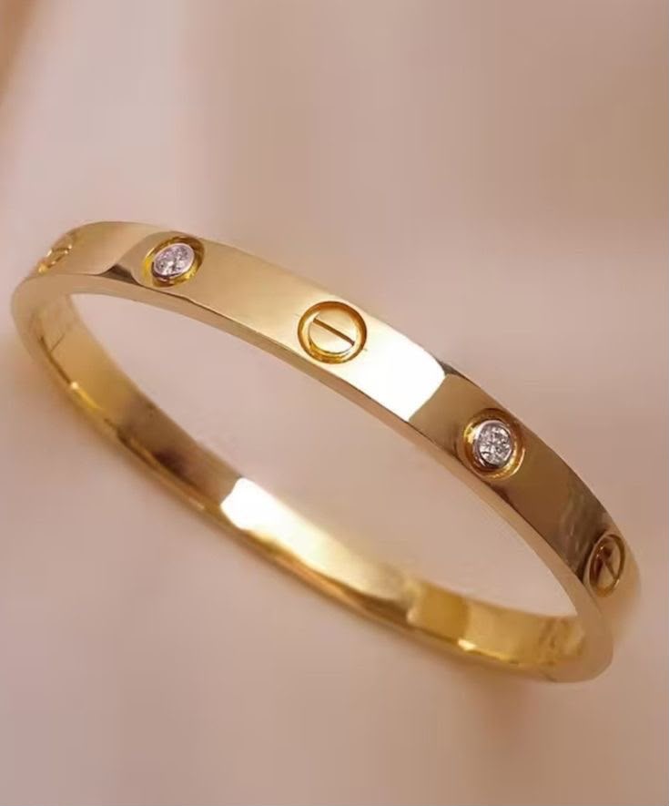 Gold ring with diamonds on a beige background